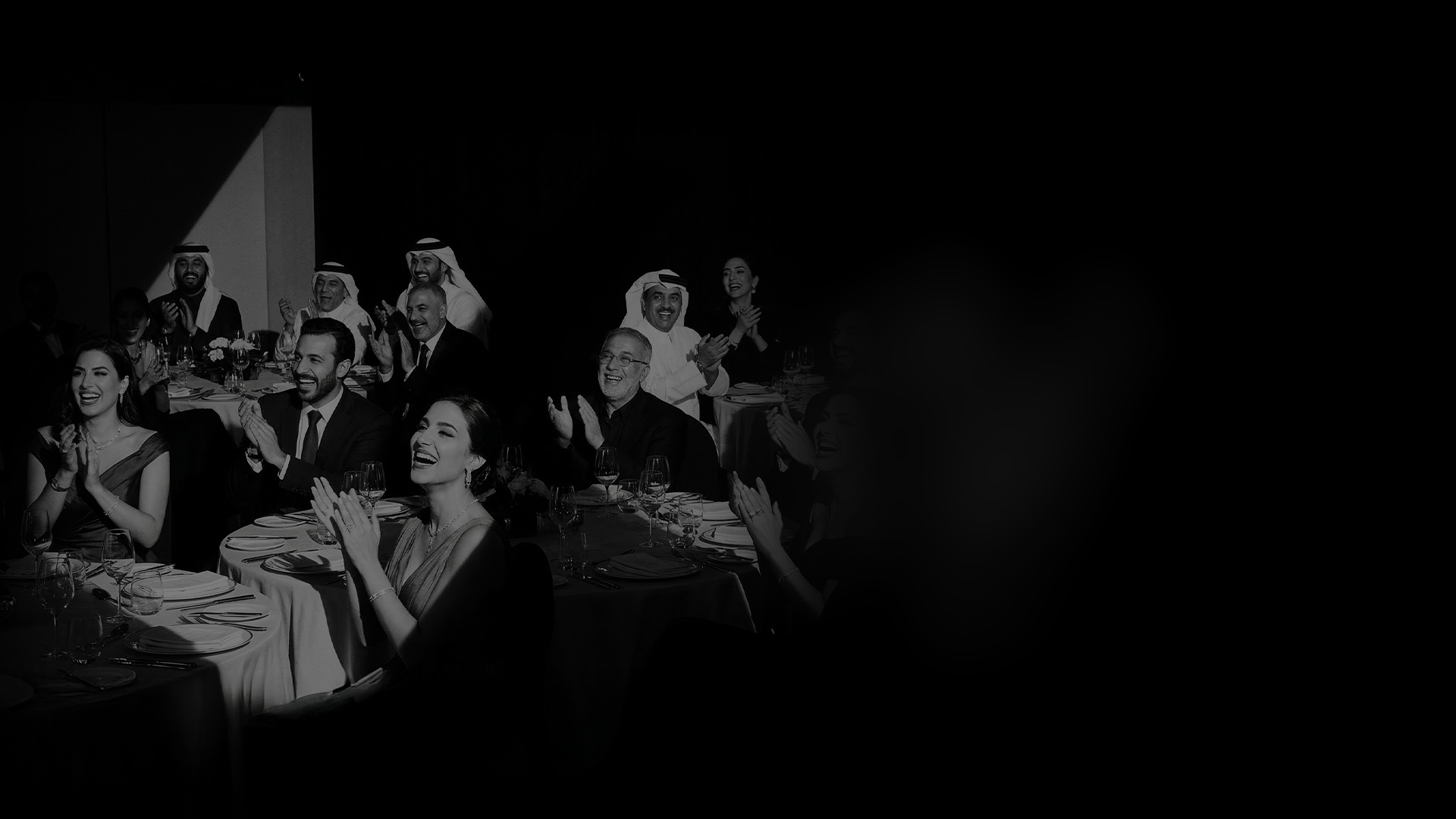 Audience in Riyadh applauding during a private salon performance.